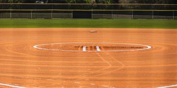 Empty baseball diamond with well-maintained dirt and grass.