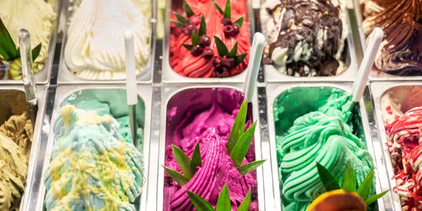 Colorful gelato flavors in a display case.