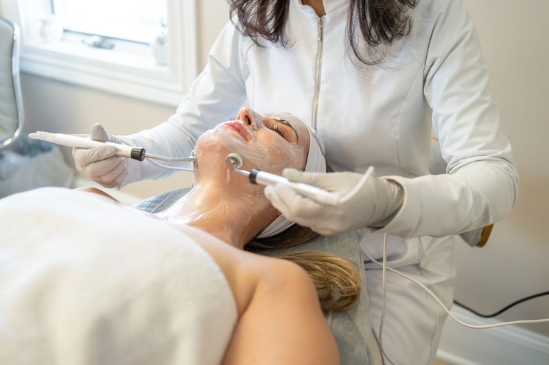 Dermatologist performing a skin treatment in a patient in a clinic using equipments