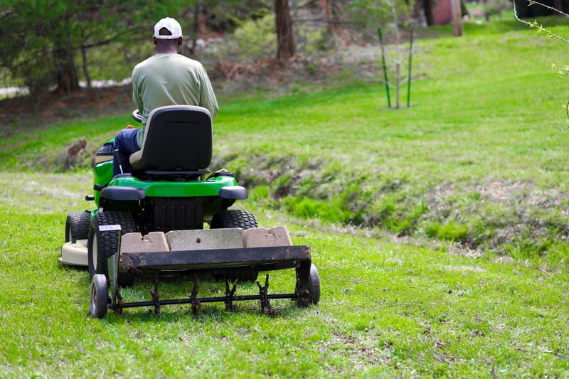 A Portrait Of A Black Man Tilling A Lawn