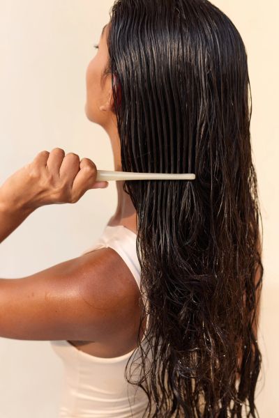 Model showcasing natural textured hair in outdoor setting