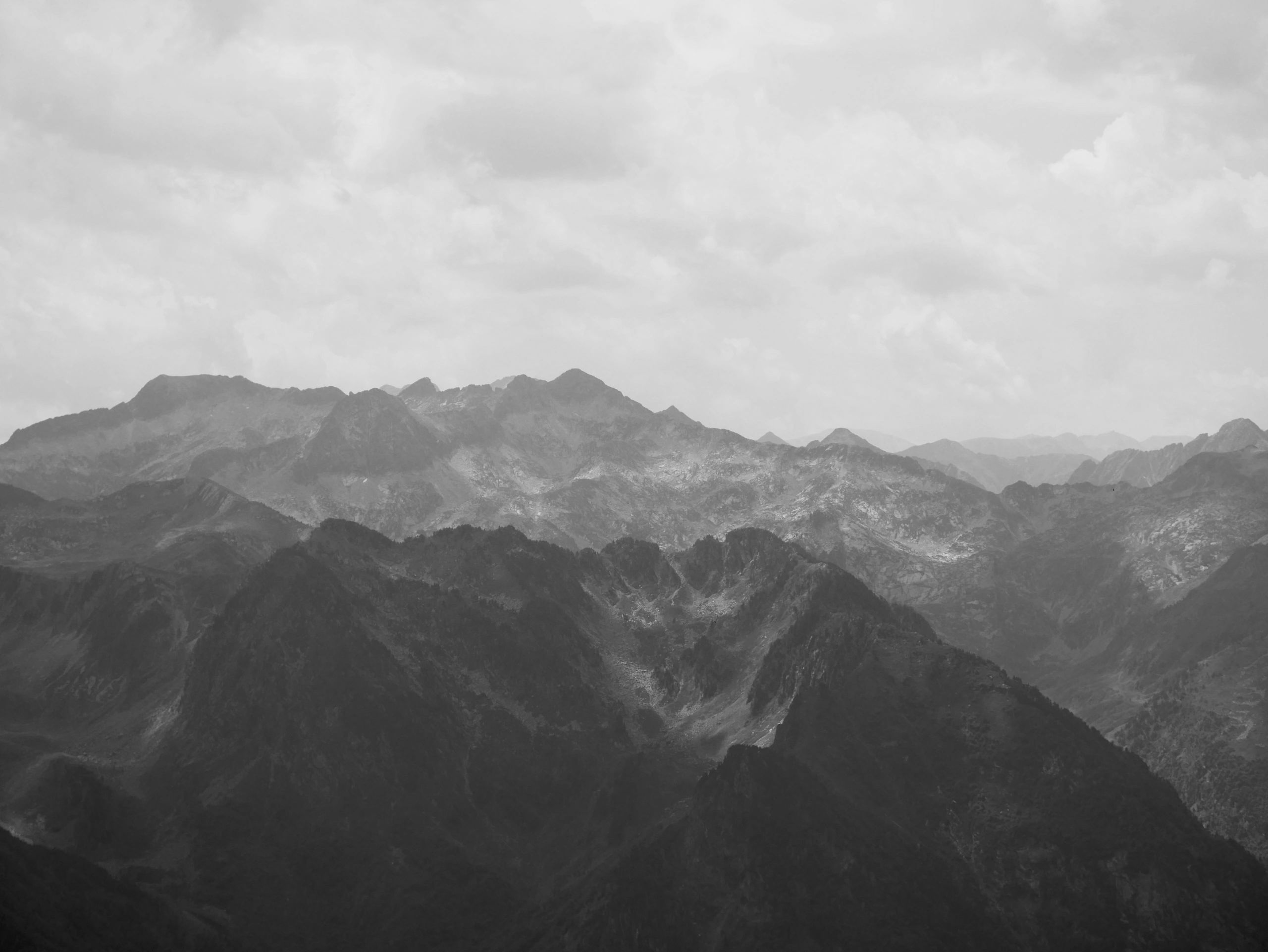 Stack of books next to pencils in a holder and a camera.