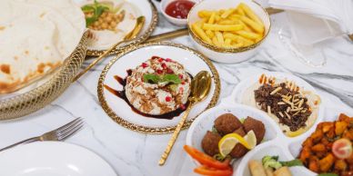 Middle Eastern meal with various dishes and pita bread.