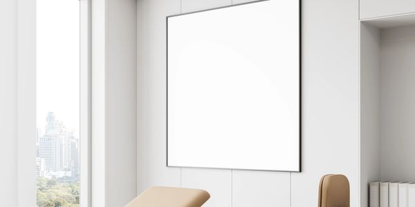 Modern, minimalistic medical examination room with beige and white tones.