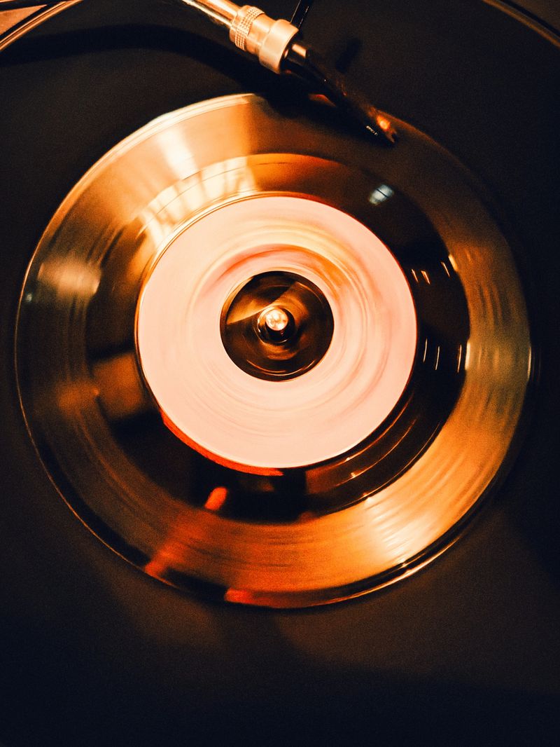 Close-up of a running record player directly from above with a record in retro style.