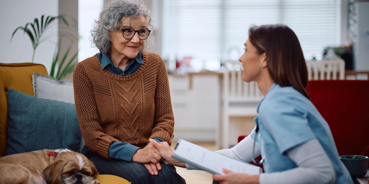 Concierge home care nurse helping senior with insurance paperwork