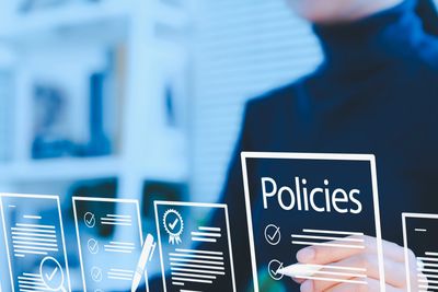 Person interacting with digital policy documents on a virtual interface.