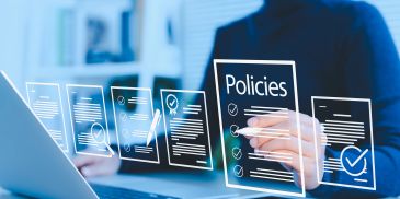 Person reviewing digital policies on a transparent interface.