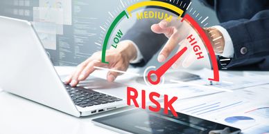 Businessman analyzing high risk on laptop.