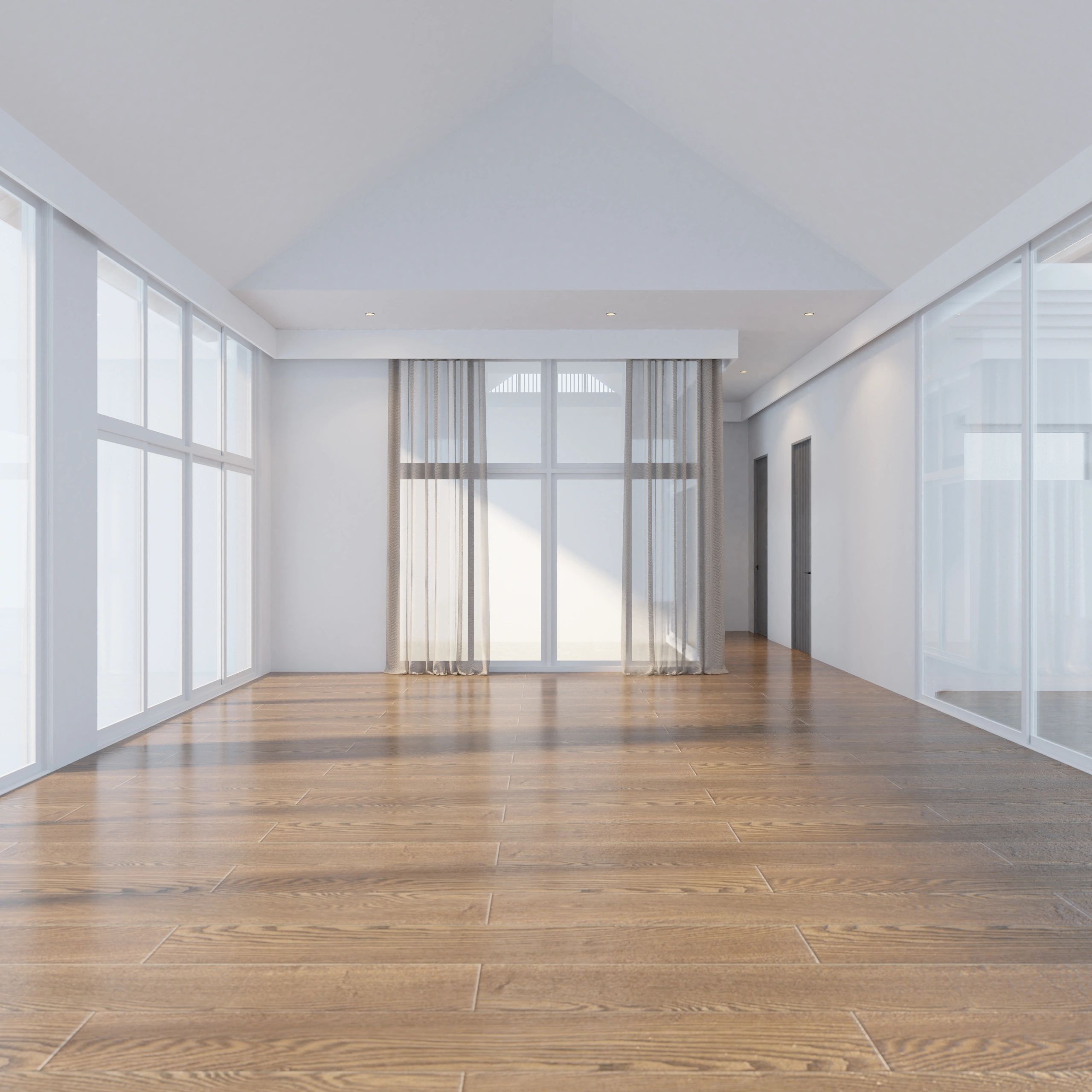 Spacious empty room with wood flooring and large windows.