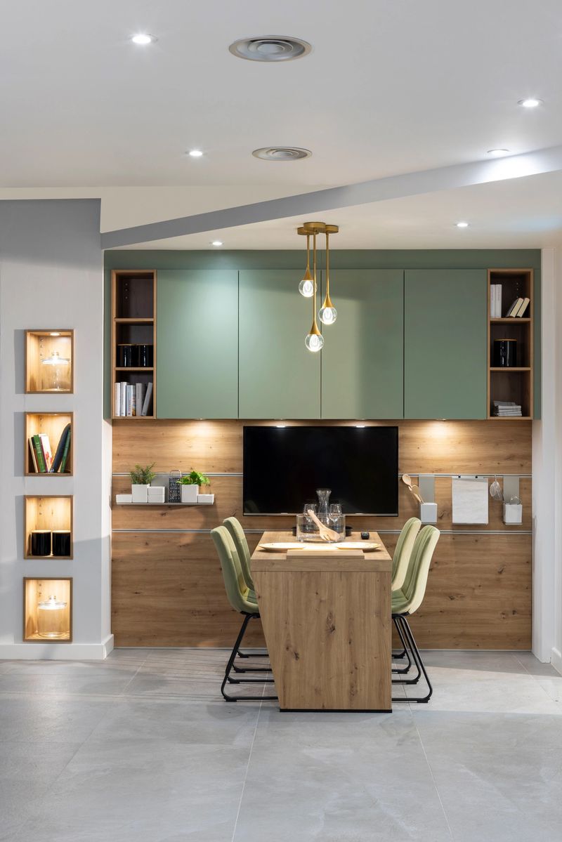 A wide shot of an elegant newly designed dining area featuring a large television and plenty of storage. The dining room is brightly lit and inviting. Located in Hexham, Northumberland.Videos are also available for this scenario.
