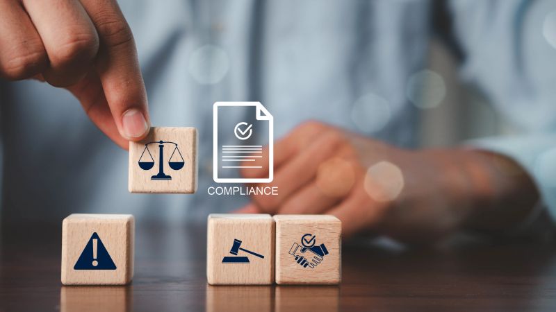 Compliance in business concept.Concept of compliance with icons on wooden cubes. Laws concept. Enforce laws, regulations and standards, comply with business policies.