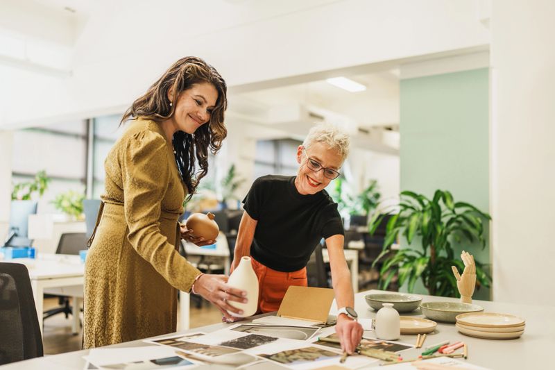 Creative agency professionals collaborating on a design project in a modern office