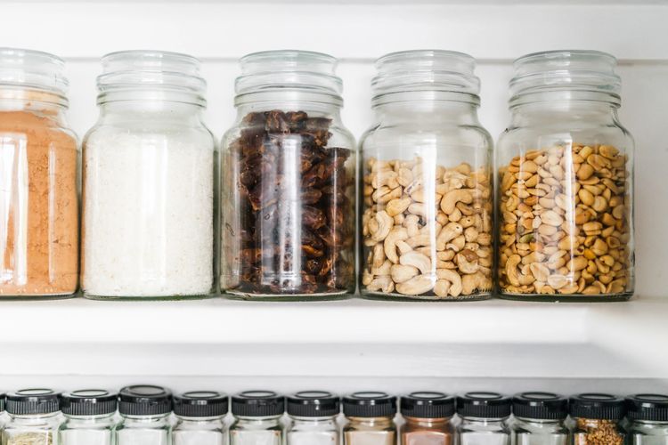 Organized stored pantry goods, glass jars, spices