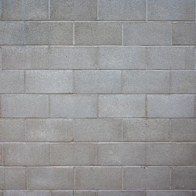 Gray concrete block wall with visible lines and texture.