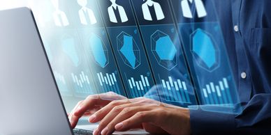 Hands typing on a laptop with digital profiles and data analysis graphics.