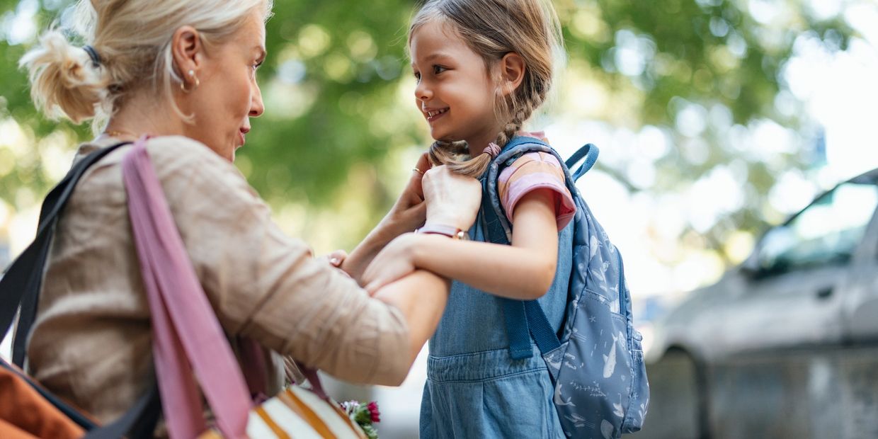 Family happily outdoors in their community.