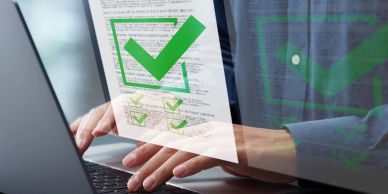 Hands typing on a laptop with green check marks overlay.