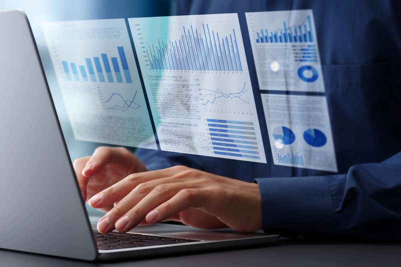 Preparing report and document about finance or market. Reviewing and documentation. Hands typing on laptop computer keyboard. Businessman working at desk in office.