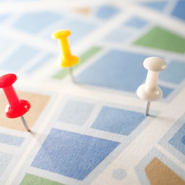 Colorful push pins marking locations on a map.