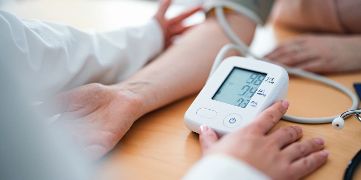 Close-up of a blood pressure monitor measuring a patient's arm.