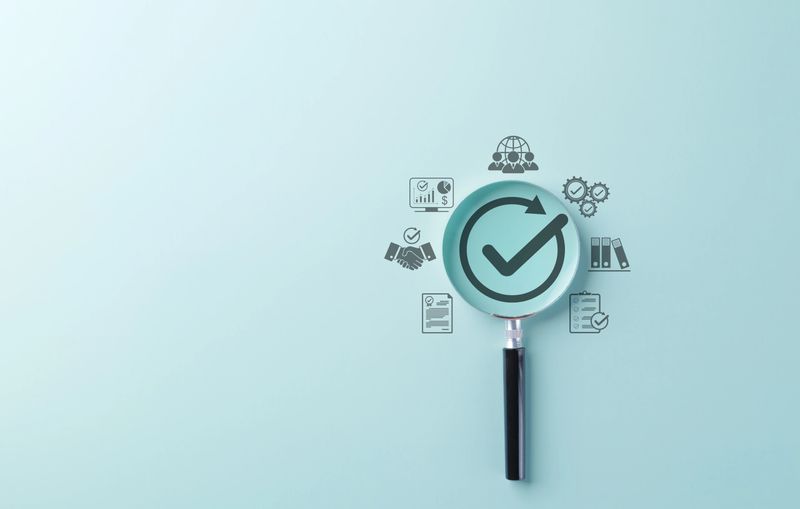 Quality Assurance and Certification Compliance Concept. A magnifying glass with checkmark surrounded by business icon, symbolizing quality assurance, compliance, and certification. certified document,