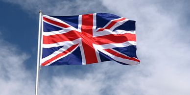 Union flag of the UK flying with the blue sky in the background