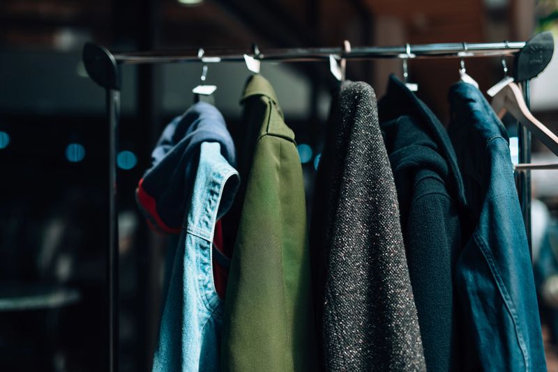 Promoting conscious consumerism and sustainable fashion, several clothes are hanging on a rack, showcasing a commitment to eco-friendly practices in the fashion industry