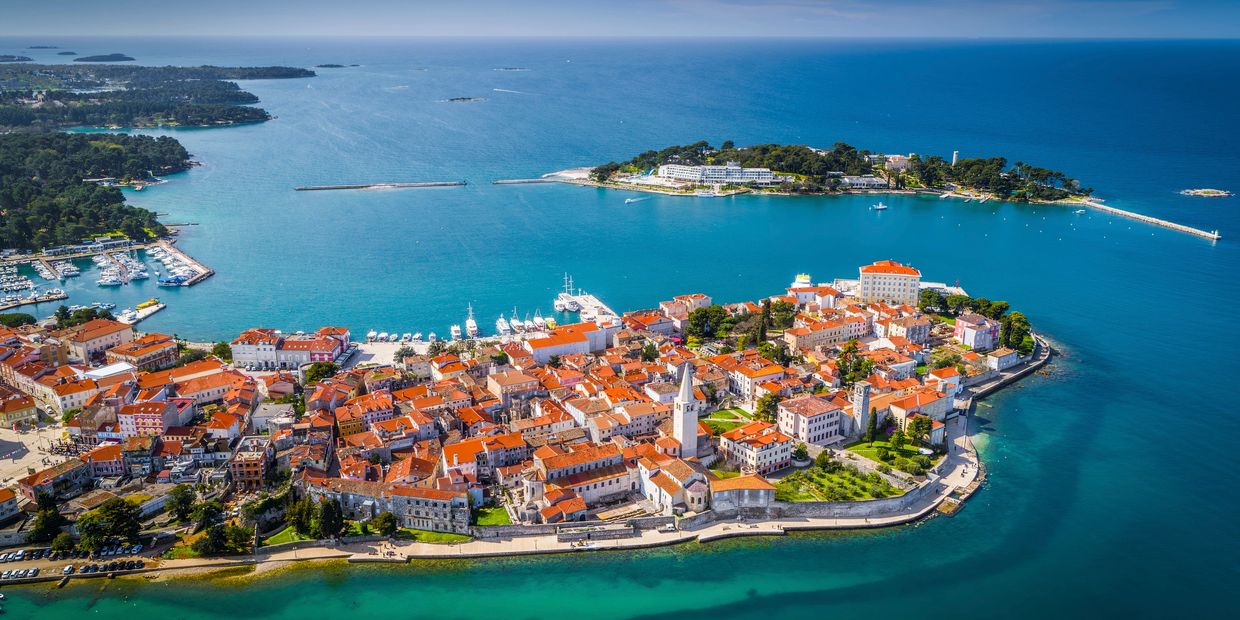 Aerial view of a coastal town with red-roofed buildings.