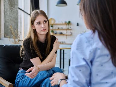 A young woman speaking to  a therapist
