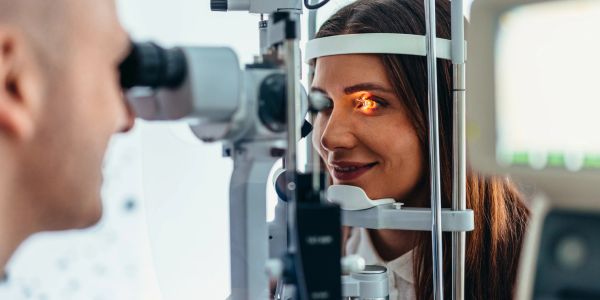 Woman undergoing an eye exam with a slit lamp.