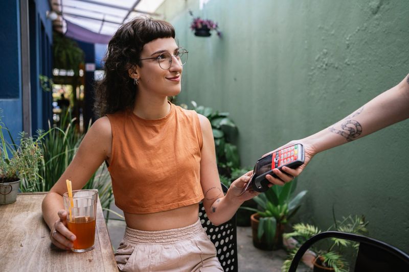 Young woman making payment with credit card