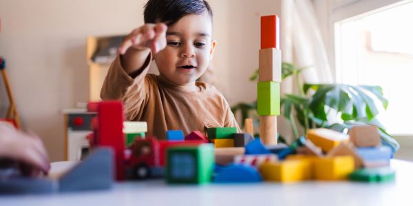 A child playing with colorful building blocks.