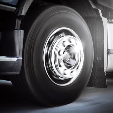 Close-up of a spinning truck tire in motion.