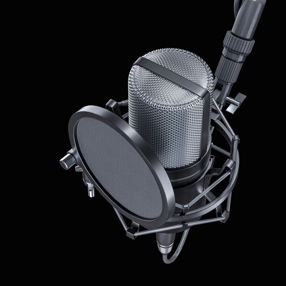 Close-up of a professional studio microphone with pop filter on black background.