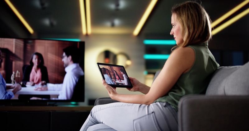 Digital Streaming: Young Female Using Tablet To Watch TV Show