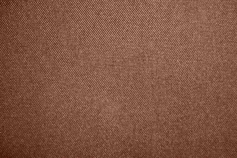Photo of textured fabric. Mocha Mousse. Different shadows of brown color. The texture of fabrics consists of small dots. Intertwined threads. Material, fabric, wallpaper, decor.