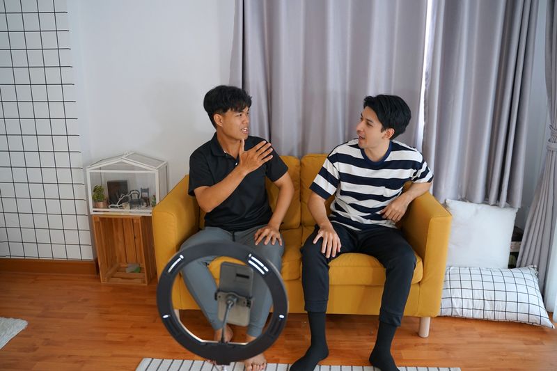 Smart  influencer is livestreaming in living room. Social media and technology.