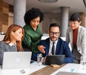 Business team discussing ideas with technology and innovation icons above them.