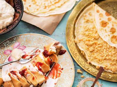 Friends celebrating with delicious crepes at a lively party.