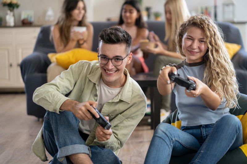 Friends having fun while playing video games together