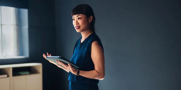 A woman presenting in a professional setting. 