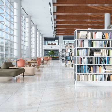 Modern library interior with bookshelves and seating area.