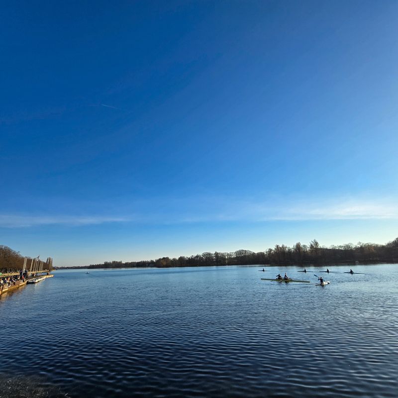 A group of enthusiastic individuals are happily rowing their kayaks on a beautiful, serene lake surrounded by natures tranquility Hannover Maschsee Lower Saxony