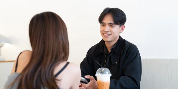 Young couple having a conversation at a cafe.