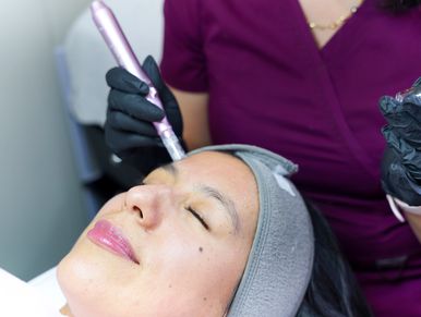 Woman receiving facial treatment.
