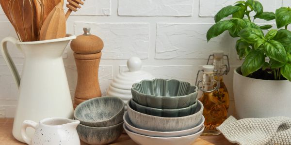 Kitchen setup with bowls, utensils, and herbs.