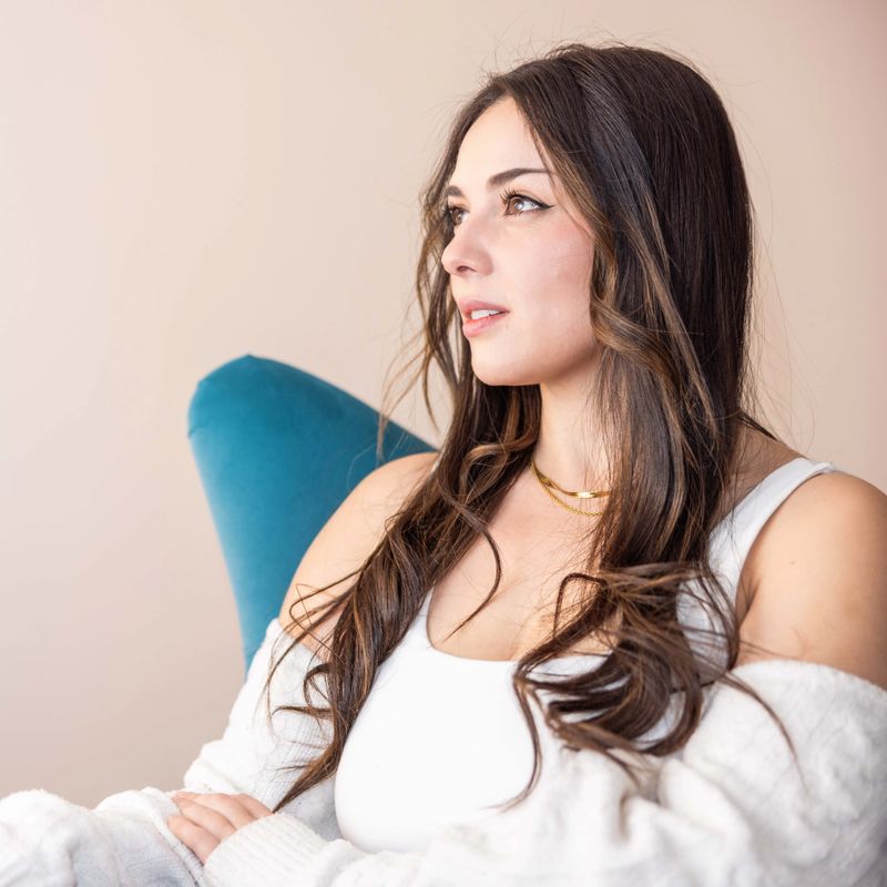 Portrait of a beautiful woman sitting at home relaxing and thinking
