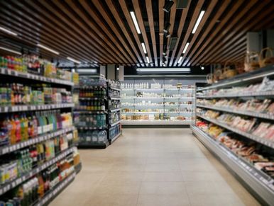 A grocery store aisle with shelves stocked.