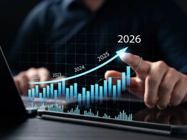 Person interacting with a digital growth chart projecting upward to 2026.